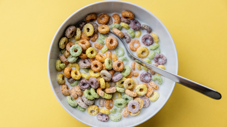 ring-shaped fruit cereal with milk in a white bowl