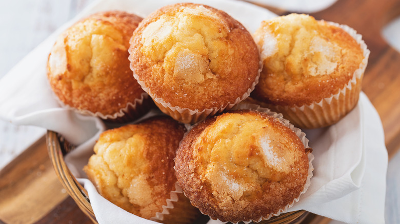 A basket of lemon muffins in muffin cases