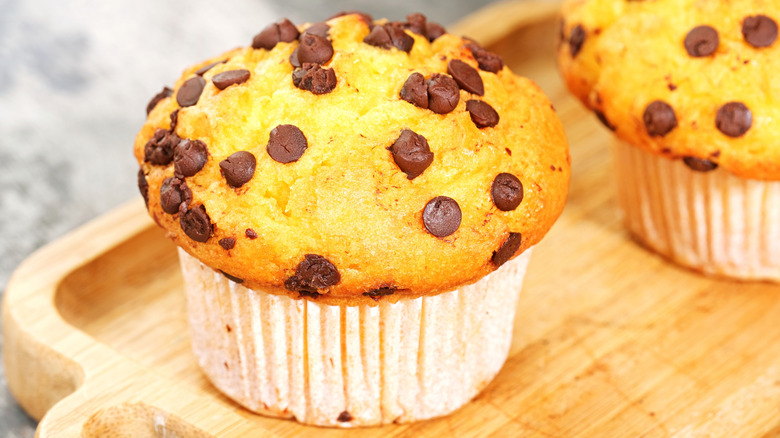 Chocolate chip muffins on a wooden board