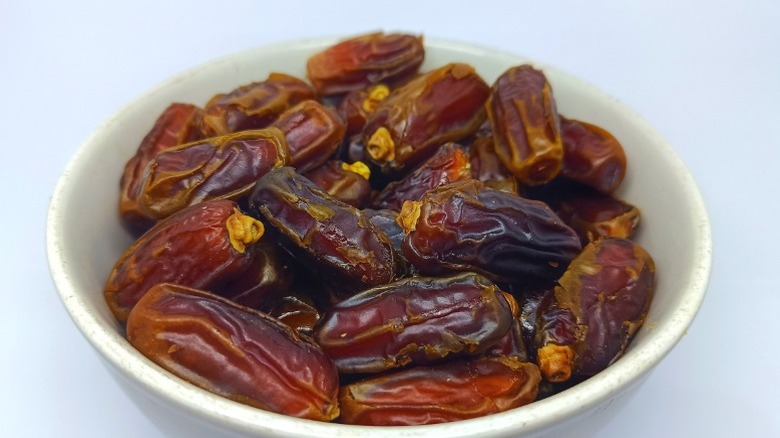 A bowl of mabroom dates in a ceramic bowl.