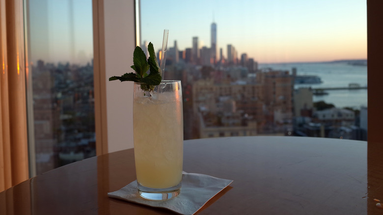 cocktail on table with New York City skyline in background