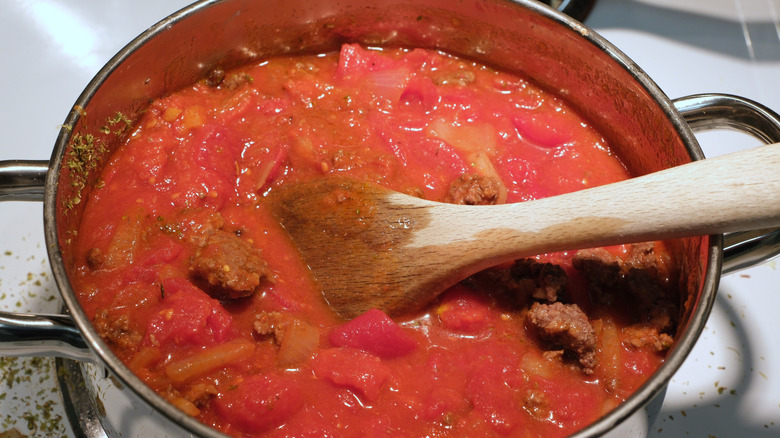 A pot of spaghetti sauce with chunks of meat