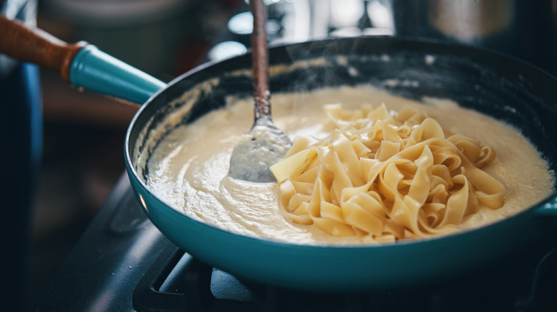 A pan of fettucine in alfredo sauce