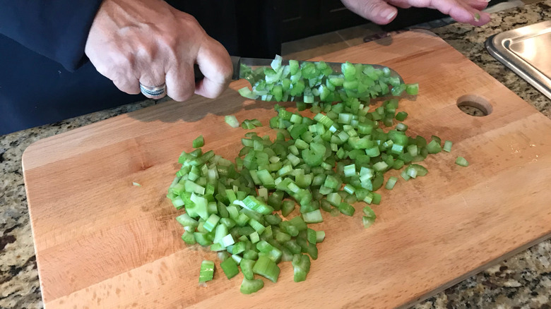 Dicing celery on a cutting board