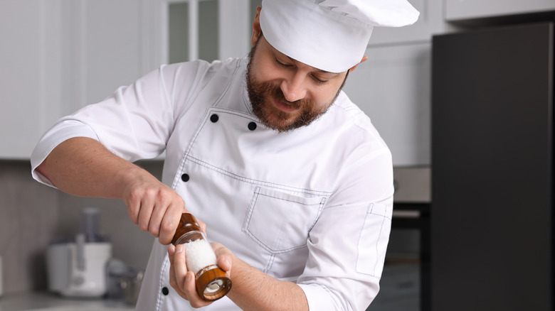 Chef liberally adding salt