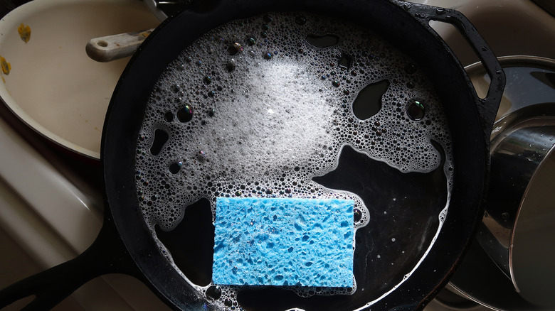 Washing a cast iron skillet with soap and water