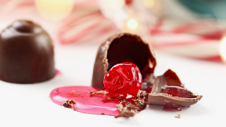 Three cordial cherries, one split open