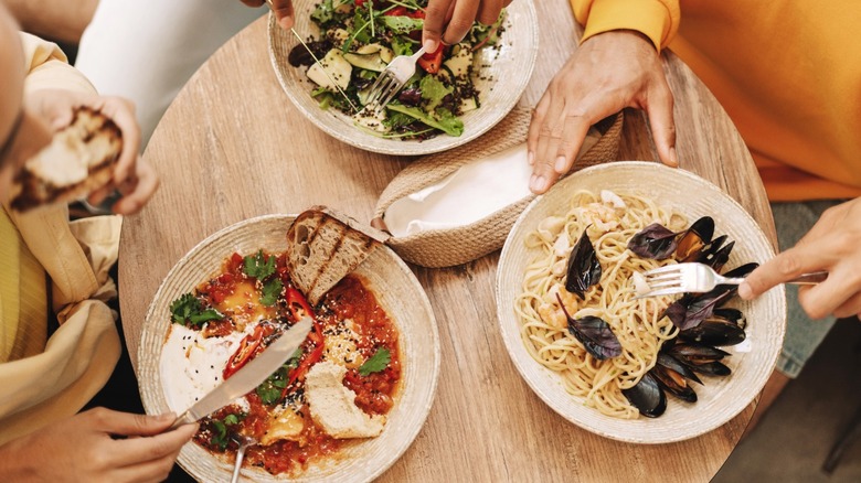 An overhead view of three diners at a restaurant