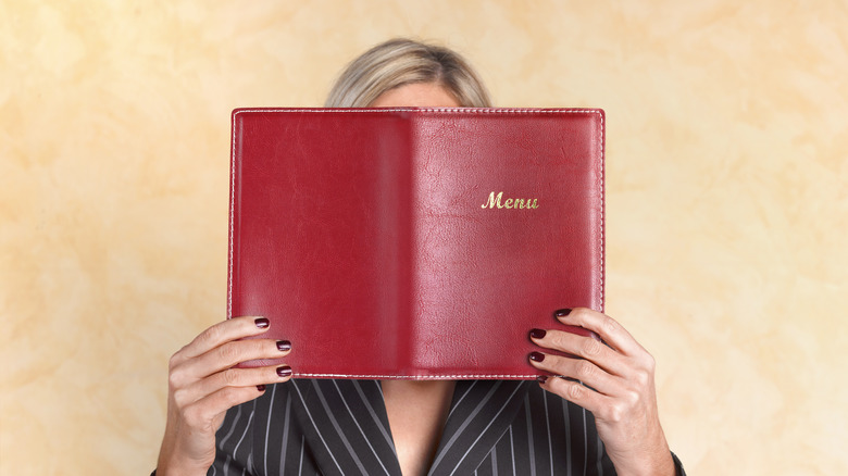 Person reading menu