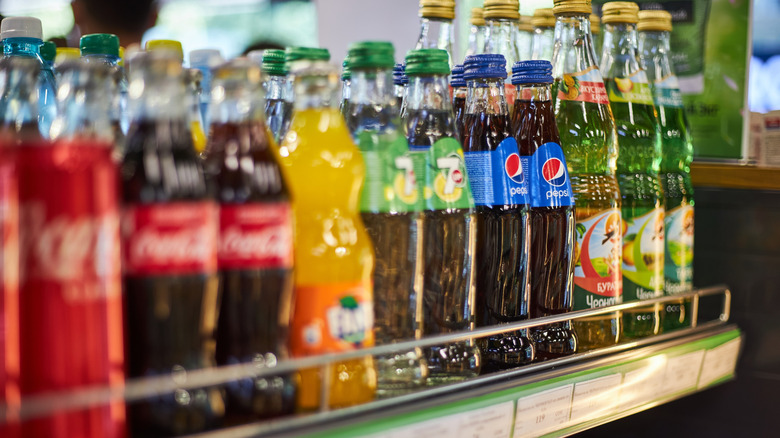 A row of different sodas with Pepsi bottles in focus