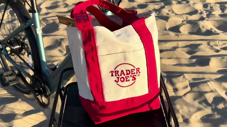 A Trader Joe's tote bag on a bike.