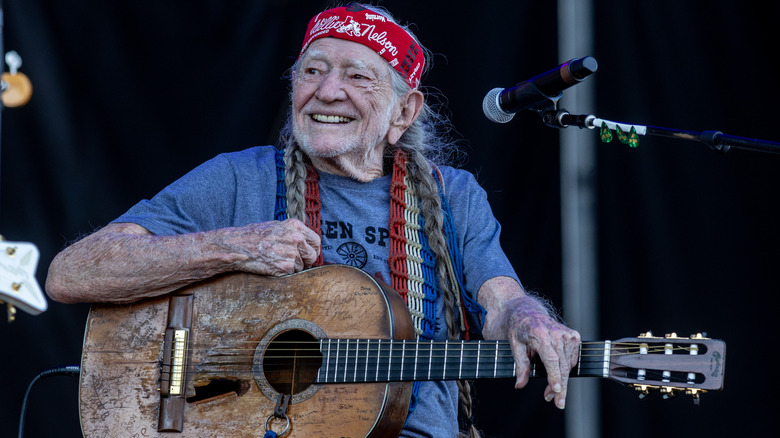 willie nelson on stage with guitar