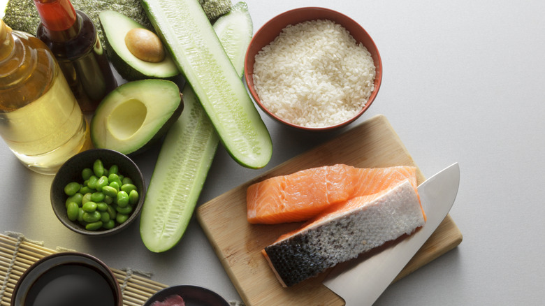 the ingredients to make sushi artfully arranged on a beige background