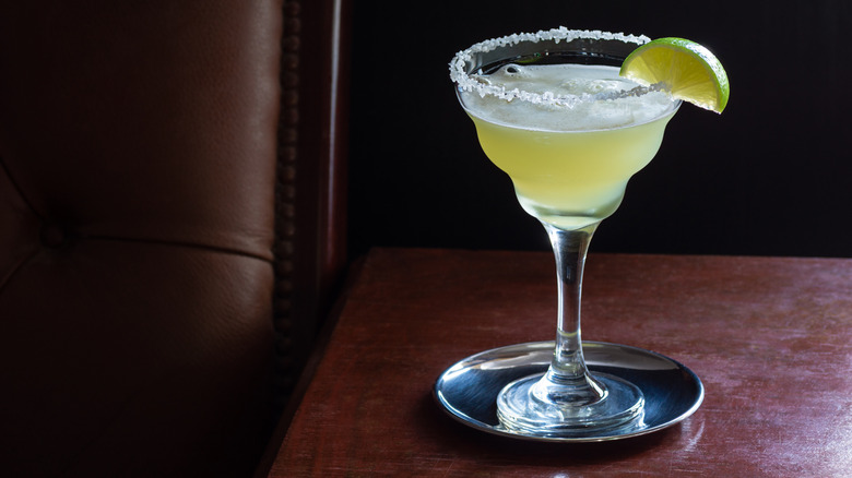 A margarita served straight up on a dark background