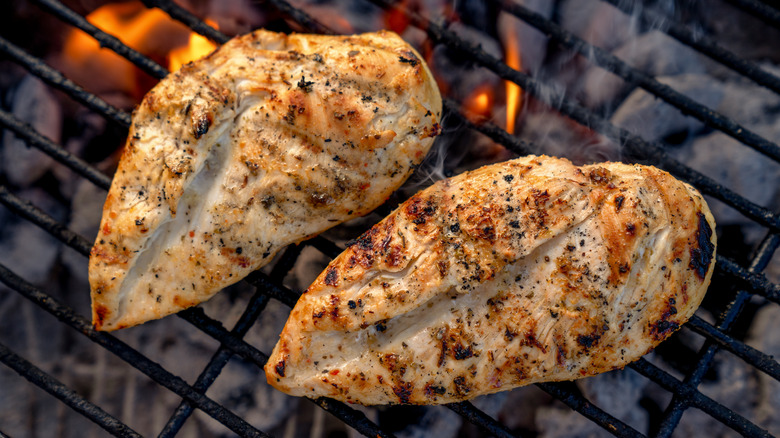 Two chicken breasts on a grill