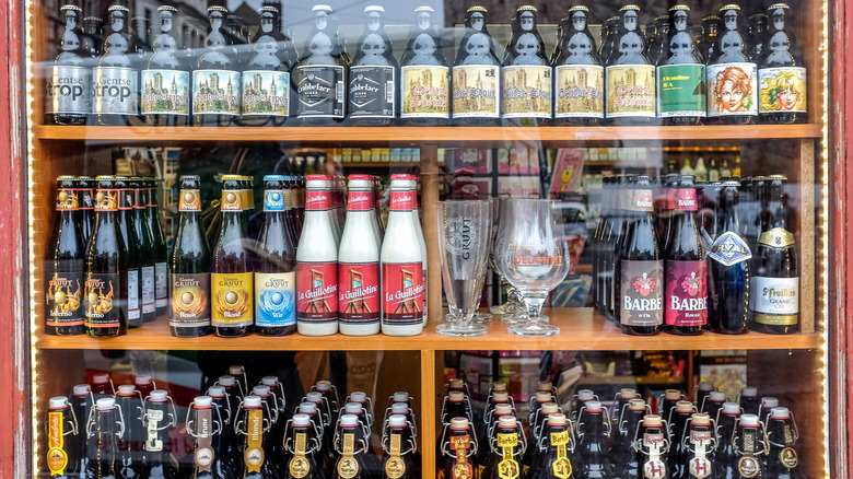 A display of Belgian beers and glassware.