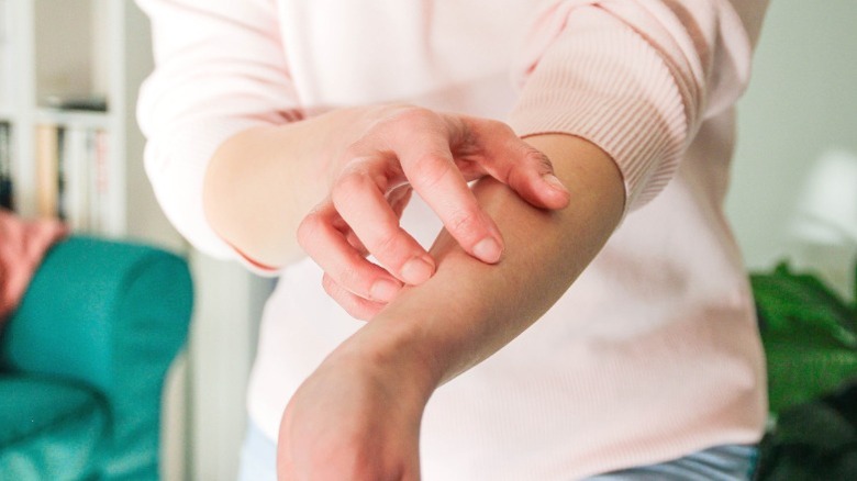 A person scratching their arm