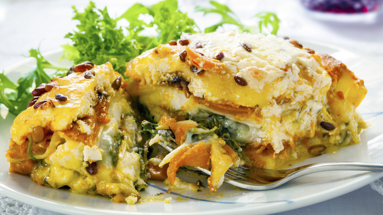 pumpkin, spinach, and sweet potato lasagna on a white plate