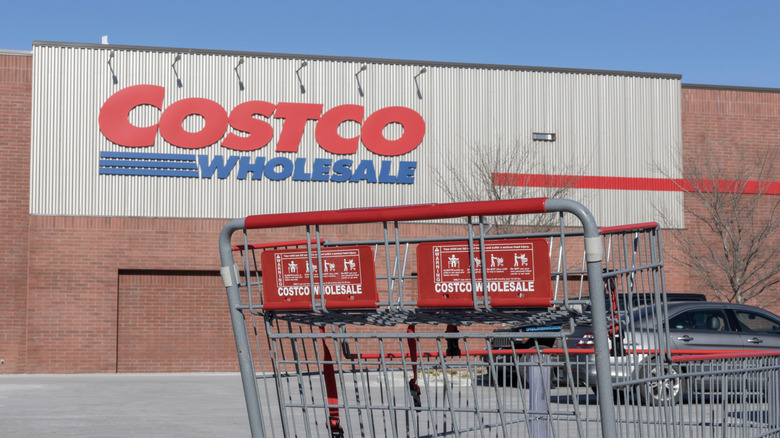 Front view of a Costco store with a shopping cart in the front