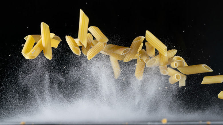 Penne noodles on a black background