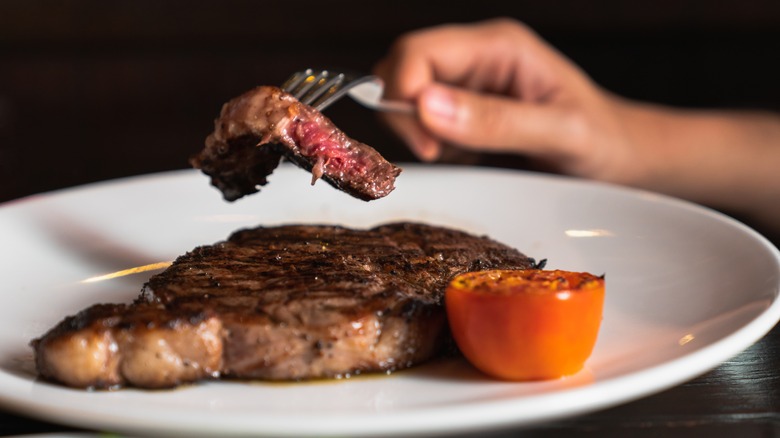 eating steak at restaurant