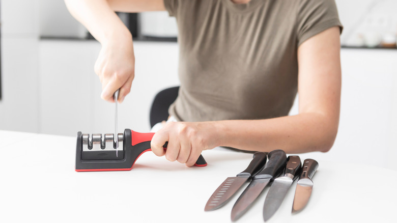 A woman sharpening knives