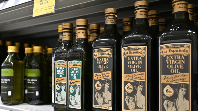 Shelf with bottles of extra virgin olive oil