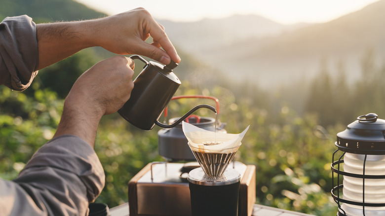 A person making pour-over coffee