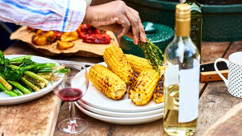 bottle of white wine with grilled corn and asparagus