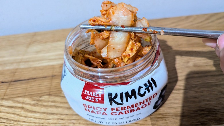 trader joe's kimchi held in chopsticks