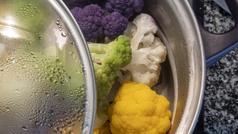 Multiple colors of cauliflower steamed in a pot