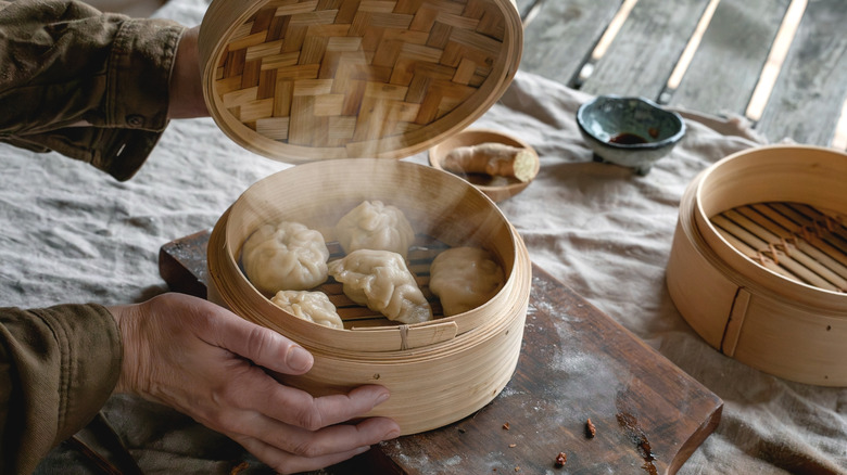 Piping hot dumplings in a bamboo steamer basket