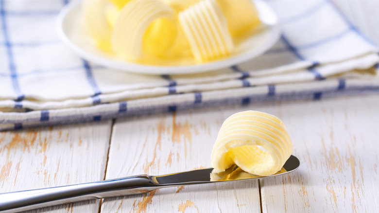 Swirls of margarine on a plate and a knife