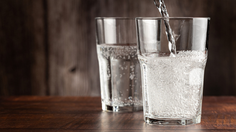 Pouring sparkling water into a glass