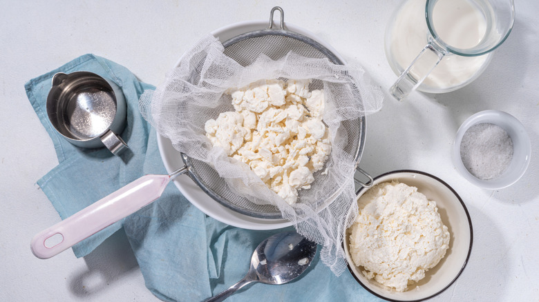 cheese curds sitting in a bowl and sieve