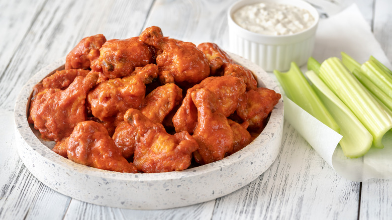 Pile of chicken wings with celery and blue cheese