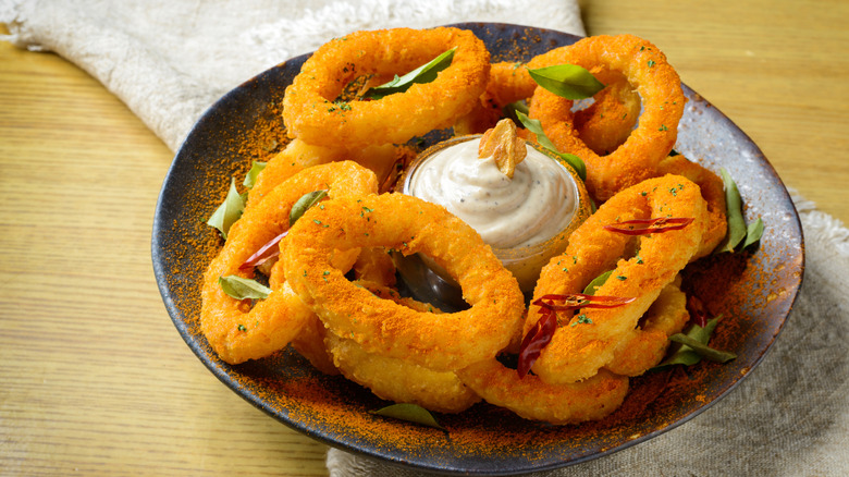 Onion rings on plate with dip