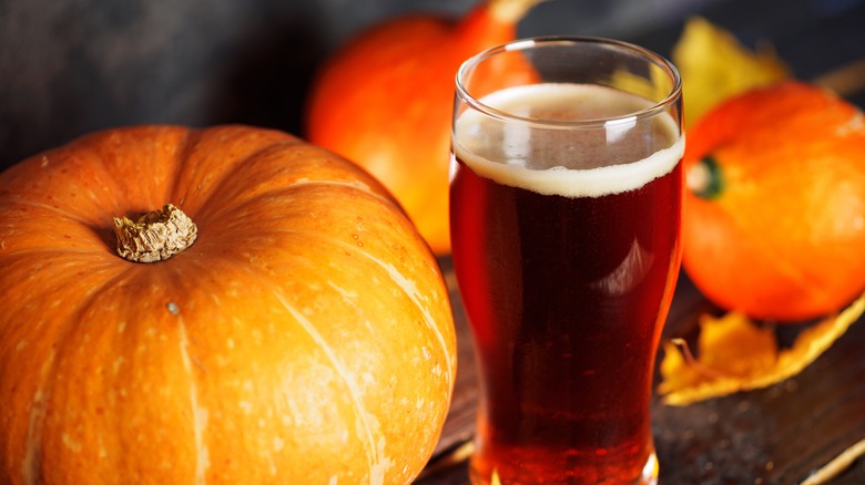 pumpkin beer surrounded by pumpkins