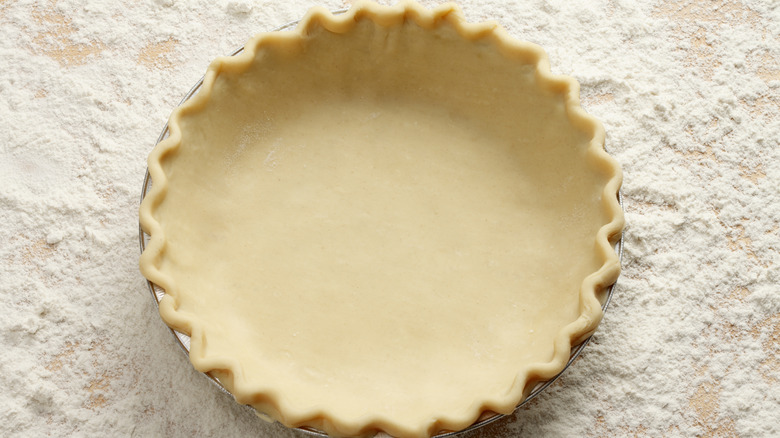 An unbaked pie crust placed inside of a pie dish