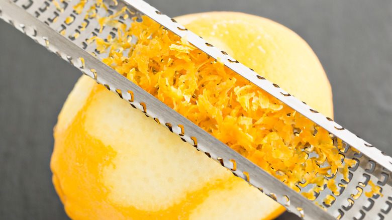 Zesting a lemon with the rasp-style grater flipped upside down